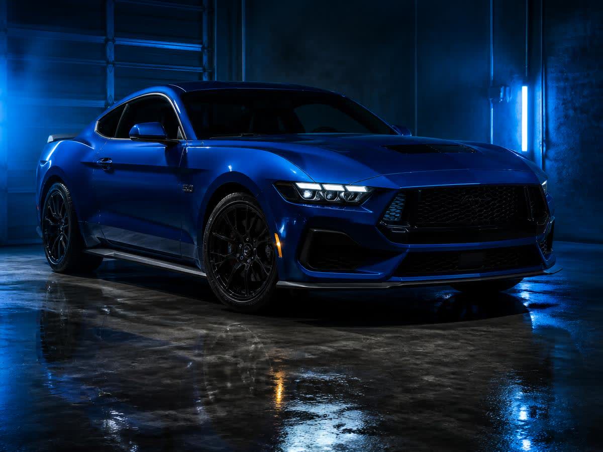 Blue Ford Mustang performance coupe in a dark garage